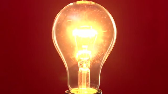 lamp lights up and goes out on a red background.
