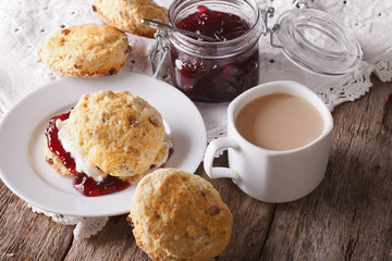 Homemade buns with jam and tea with milk close-up. horizontal
