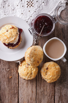 Delicious English scones with jam and tea. vertical top view
