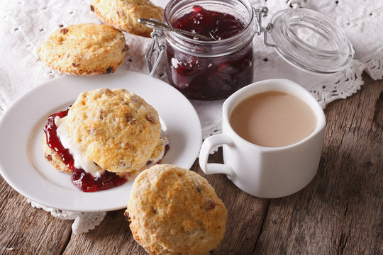 Homemade buns with jam and tea with milk close-up. horizontal
