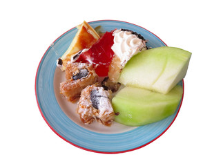 Dessert on dish - cakes and mellon isolated over white