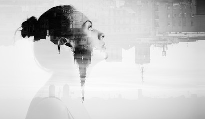 Monochrome double exposure with attractive young woman and beautiful city