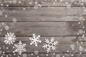 Snowflakes on grunge wooden background
