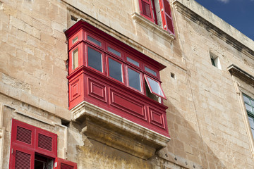 Fototapeta na wymiar Typical wooden balcony on old building in capital of Malta, Valletta