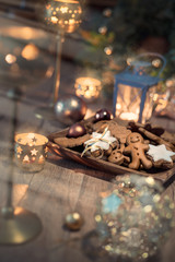 Christmas cookies on decorated table with candles
