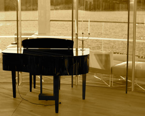 Panoramic sea view with piano in foreground.