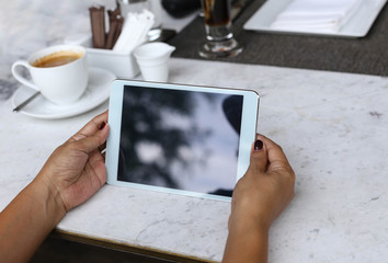 women hands with tablet computer and cup off coffee