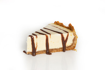 Slice of cheesecake with chocolate on a white background