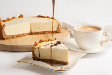 Cheesecake with chocolate and coffee on a white table
