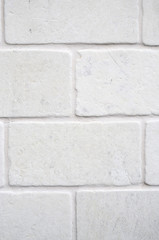 Decorative white cladding slabs imitating stones on wall