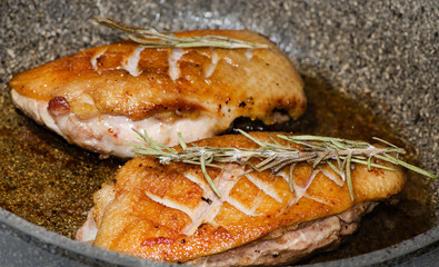 process of cooking meat, duck breast fried in a pan