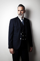 Portrait of stylish middle aged man wearing trendy suit. Vertical