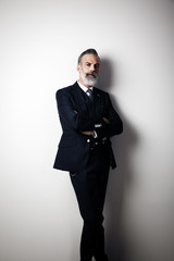 Portrait of handsome middle aged man wearing trendy suit. Vertical