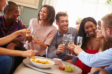 Obraz na płótnie Canvas Group Of Friends Celebrating With A Toast At Home