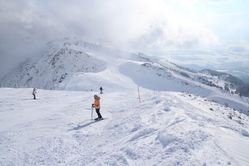 Fototapeta na wymiar Ski slope with skiers 