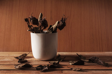 Leaf of rose fall on wooden table