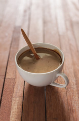 Cup of coffee on wooden and blur background