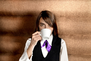 Girl in a uniform drinking coffee
