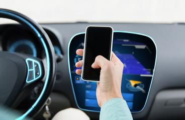 close up of male hand with smartphone driving car