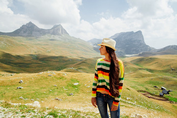 Fototapeta na wymiar woman relax on peak of mountain with picturesque view