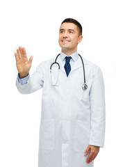 smiling male doctor touching something