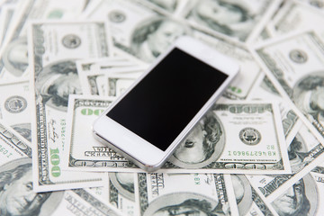 close up of smartphone and dollar money