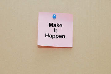 Words of Make It Happen on sticky color papers stick on brown cardboard