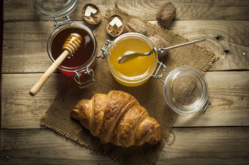 Croissants with honey in a rustic style