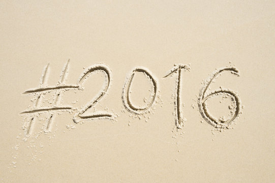 Hashtag social media message for 2016 written in smooth sand on the beach in Rio de Janeiro, Brazil