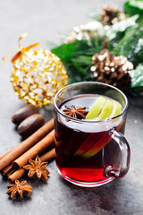Mulled red wine with apple slices and spices