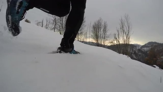 Man running in snow at sunset