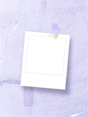 Single square empty photo frame with scotch tape on light blue plastic background