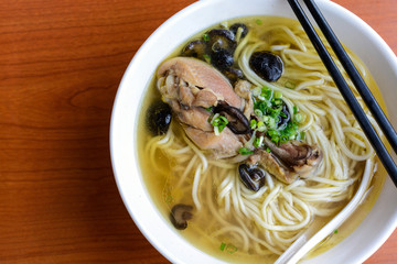 Braised chicken noodle soup on wooden table, Chinese style
