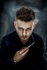 Elegant young handsome man. Studio fashion portrait.Portrait of a young brutal man with straight razor