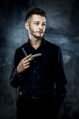 Elegant young handsome man. Studio fashion portrait.Portrait of a young brutal man with straight razor