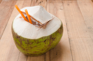 Fresh coconut juice drink on wood panel