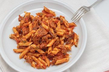Macaroni with tomato sauce, sausage and pepper.