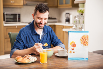 Fototapeta na wymiar Guy eating cereal for breakfast