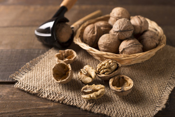 Whole and chopped walnuts on old wooden table