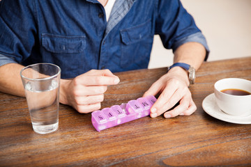 Man taking vitamins at home