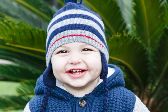 little happy boy one year old outdoors in spring or autumn portrait