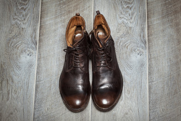 beautiful high leather men's shoes on a wooden floor