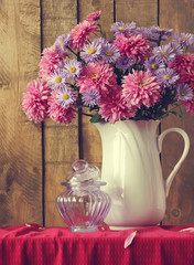 Still life with a bouquet of pink and violet chrysanthemums a wh