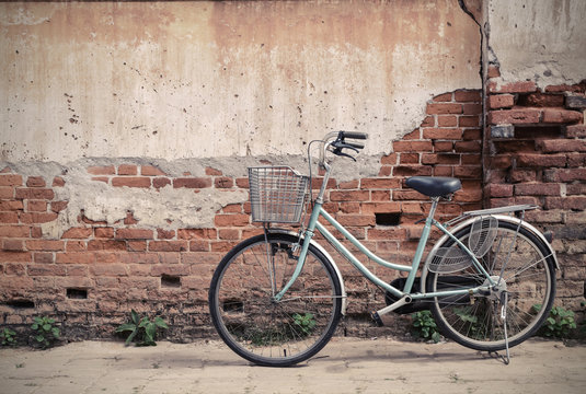 Vintage bicycle with old brick wall