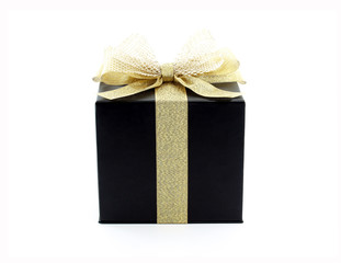 luxury black gift box with glittering gold ribbon and net tied bow isolated on white