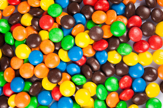 Close up of a pile of colorful chocolate coated candy . color ca