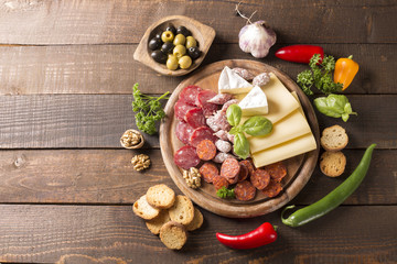 appetizer with sausages,cheese,olive and nuts
