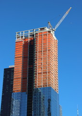 Skyscraper Building Site Half Completed with Top Crane