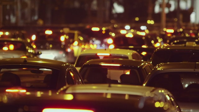 Night traffic jam at city telephoto lens cars grind to a halt on avenue