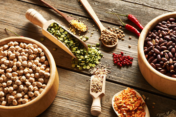 Bowls and spoons of various legumes